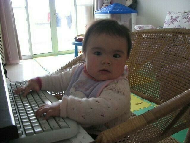 Baby sitting at computer