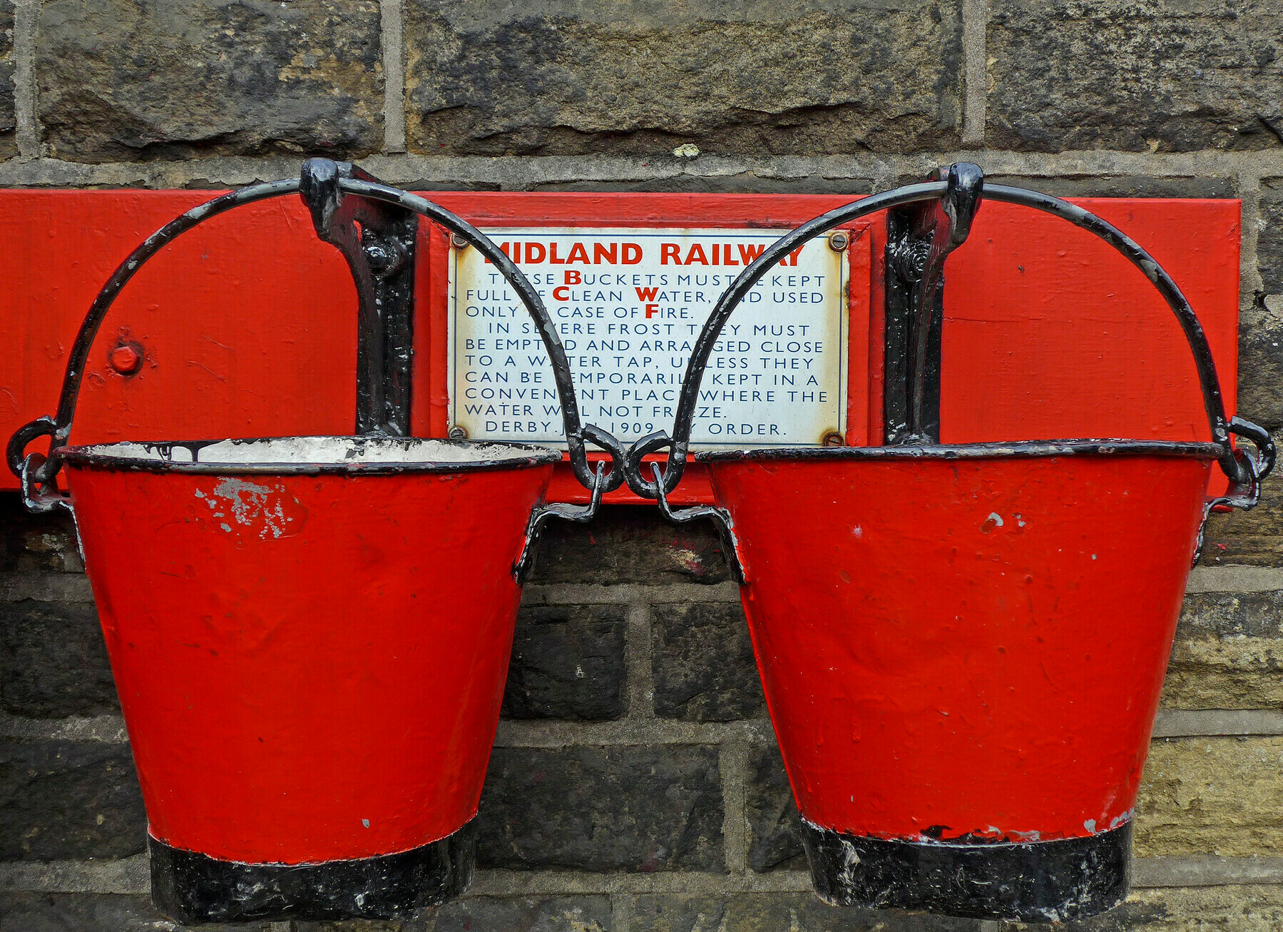 two red buckets for fire prevention